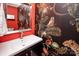 Powder room featuring vibrant wallpaper and sleek black vanity at 6425 High Creek Ct, Charlotte, NC 28277