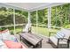 Screened in porch with comfortable seating and peaceful backyard views at 6425 High Creek Ct, Charlotte, NC 28277