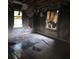 Bedroom with windows and significant fire damage and debris at 721 S Spruce St, Rock Hill, SC 29730