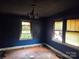 Bedroom with hardwood floors, windows, and fire damage at 721 S Spruce St, Rock Hill, SC 29730