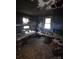 Heavily damaged bedroom featuring two beds, peeling blue walls, and water damaged floors at 721 S Spruce St, Rock Hill, SC 29730