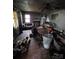 Damaged living room interior displaying debris, damaged walls, and a non-functional fireplace at 721 S Spruce St, Rock Hill, SC 29730