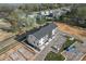 New construction townhome with modern architecture, gray roof, parking lot, and verdant landscaping at 722 Falling Oak Aly # 20, Huntersville, NC 28078