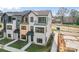 Townhome showcasing a modern exterior with brick accents, private balconies, and well-maintained landscaping at 722 Falling Oak Aly # 20, Huntersville, NC 28078