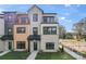 Modern townhome featuring varied exterior materials, multiple balconies, and manicured landscaping at 722 Falling Oak Aly # 20, Huntersville, NC 28078