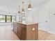 Bright kitchen features an island, pendant lighting, and stainless steel appliances at 722 Falling Oak Aly # 20, Huntersville, NC 28078