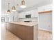 Spacious kitchen featuring an island, pendant lighting, white cabinets, and stainless steel appliances at 722 Falling Oak Aly # 20, Huntersville, NC 28078