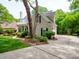 Home with mature trees, lush landscaping, and a spacious driveway at 7716 Seton House Ln, Charlotte, NC 28277