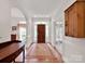 Inviting foyer with hardwood floors, arched doorways, and elegant details at 7716 Seton House Ln, Charlotte, NC 28277