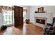 Living room featuring a fireplace, hardwood floors, and natural light at 7716 Seton House Ln, Charlotte, NC 28277
