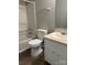 Bathroom with a tub/shower combo, updated toilet, vanity, and linoleum flooring at 8000 Tiburon Cir, Charlotte, NC 28215