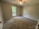 Neutral bedroom with plush carpeting and a window offering natural light at 8000 Tiburon Cir, Charlotte, NC 28215
