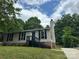 Traditional single-story home with a well-manicured lawn and mature trees at 8000 Tiburon Cir, Charlotte, NC 28215