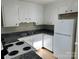 Clean kitchen featuring white appliances, ample cabinet space, and durable tile floors at 8000 Tiburon Cir, Charlotte, NC 28215
