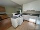 Functional kitchen with white cabinets, granite countertops, and an open layout to the dining area at 8000 Tiburon Cir, Charlotte, NC 28215