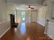 Spacious living room featuring a brick fireplace, hardwood flooring and an open layout at 8000 Tiburon Cir, Charlotte, NC 28215