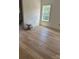 Light-filled bedroom with a window, and wood-look flooring in a newly renovated home at 85 Cornerstone Dr, Taylorsville, NC 28681