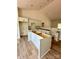 Spacious kitchen with white cabinets, island and light wood floors is undergoing renovations at 85 Cornerstone Dr, Taylorsville, NC 28681