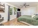 Serene main bedroom with hardwood floors, a ceiling fan, and a modern accent wall at 878 Cold Springs Rd, Concord, NC 28025