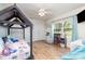 Bright bedroom featuring hardwood floors, a bed frame feature, and natural light from windows at 878 Cold Springs Rd, Concord, NC 28025