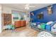 Vibrant bedroom with hardwood floors, blue accent wall, and playful décor at 878 Cold Springs Rd, Concord, NC 28025