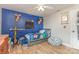 Bright bedroom with blue accent wall, hardwood floors, and fun toy displays at 878 Cold Springs Rd, Concord, NC 28025