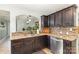 Stylish kitchen with granite countertops, stainless steel dishwasher, and dark wood cabinets at 878 Cold Springs Rd, Concord, NC 28025