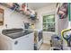 Efficient laundry room with modern washer, dryer, and ample storage at 878 Cold Springs Rd, Concord, NC 28025