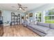 Comfortable living room featuring a gray sectional, hardwood floors, and bright natural lighting at 878 Cold Springs Rd, Concord, NC 28025