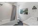 A modern bathroom with a shower-tub combo, elegant vanity, and sleek, nature-inspired decor at 9305 Valley Rd, Charlotte, NC 28270