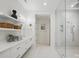 Modern bathroom with double vanity, shelving, and a large glass-enclosed shower at 9305 Valley Rd, Charlotte, NC 28270