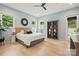 Serene bedroom features natural light, hardwood floors, a stylish bookcase, and a view of the outdoors at 9305 Valley Rd, Charlotte, NC 28270