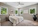 Serene bedroom with large windows offering a beautiful view, complemented by cozy furnishings and ample natural light at 9305 Valley Rd, Charlotte, NC 28270