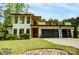 Modern two-story home with a lush green lawn and a three car garage at 9305 Valley Rd, Charlotte, NC 28270