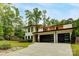 Stunning modern home with a three-car garage, accented by mature trees and landscaping at 9305 Valley Rd, Charlotte, NC 28270