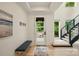 Bright foyer featuring an entry bench, modern staircase, and hardwood flooring at 9305 Valley Rd, Charlotte, NC 28270