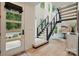 Bright foyer featuring a modern staircase, hardwood flooring, and high ceilings at 9305 Valley Rd, Charlotte, NC 28270