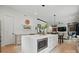 A modern kitchen with an island, stainless steel microwave, and an open floor plan with dining and living areas at 9305 Valley Rd, Charlotte, NC 28270