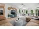 Bright living room featuring a comfortable sectional sofa, wood floors, and desk space at 9305 Valley Rd, Charlotte, NC 28270
