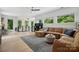 Spacious living room with a large sectional sofa, wood floors, and a staircase at 9305 Valley Rd, Charlotte, NC 28270
