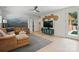 Inviting living room featuring a comfortable sectional sofa and stylish decor with scenic mural accent wall at 9305 Valley Rd, Charlotte, NC 28270