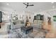 Open-concept living room with hardwood floors, plush seating, and a stylish ceiling fan at 9305 Valley Rd, Charlotte, NC 28270
