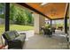 Covered patio with a fireplace, outdoor seating, a ceiling fan, and a view of the spacious backyard at 9305 Valley Rd, Charlotte, NC 28270