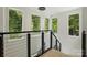 Contemporary staircase with black railings and many windows with natural views at 9305 Valley Rd, Charlotte, NC 28270