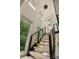 Modern staircase with black and silver railings and several windows that provide lots of light at 9305 Valley Rd, Charlotte, NC 28270