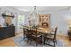 Elegant dining room features a light wood table, seating for six, and traditional chandelier at 9707 Enid Ln, Matthews, NC 28105