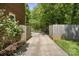 Long private driveway bordered by wood fence and lush greenery at 9707 Enid Ln, Matthews, NC 28105
