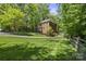 Charming two-story brick home with lush green lawn and mature trees at 9707 Enid Ln, Matthews, NC 28105