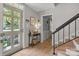 Light-filled foyer featuring hardwood floors, a stylish console table, and staircase access at 9707 Enid Ln, Matthews, NC 28105