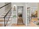 Inviting foyer with hardwood floors, stairs, and view into the kitchen and dining area at 9707 Enid Ln, Matthews, NC 28105